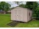 A pink storage shed with double doors and a ramp sits on a green lawn at 3424 Autumn Dr, Gastonia, NC 28056