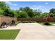 Spacious backyard featuring a concrete patio, lush greenery, and a built-in grill, perfect for outdoor entertaining at 4021 Redwood Ave, Charlotte, NC 28205
