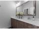 Bathroom featuring a large mirror and double sinks on a wooden vanity with white countertops at 4021 Redwood Ave, Charlotte, NC 28205