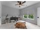 Neutral bedroom with a ceiling fan, two windows for light, and unique decorative items and furniture at 4021 Redwood Ave, Charlotte, NC 28205