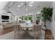 Open concept dining room with elegant chandelier and access to the outdoor living space at 4021 Redwood Ave, Charlotte, NC 28205