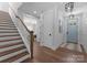Inviting entryway with hardwood floors, staircase, and view into other living spaces at 4021 Redwood Ave, Charlotte, NC 28205