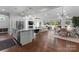 Open-concept living area with kitchen island, modern appliances, and views of backyard at 4021 Redwood Ave, Charlotte, NC 28205