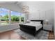 Bright main bedroom with a decorative ceiling light fixture and large windows at 4021 Redwood Ave, Charlotte, NC 28205