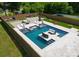 Stunning backyard aerial view features a modern pool with in-water seating, complemented by lounge areas at 4021 Redwood Ave, Charlotte, NC 28205