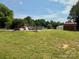 Green backyard with an above-ground pool and a shed at 403 Kings Dr, Cherryville, NC 28021