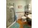 This bathroom features a glass door shower, classic tiling, and hardwood floors at 403 Kings Dr, Cherryville, NC 28021