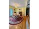 Bright dining area features hardwood floors, an ornate chandelier, and a circular rug under a round table at 403 Kings Dr, Cherryville, NC 28021