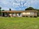 Lovely one-story home with brick details, a covered carport, front porch, and manicured lawn at 403 Kings Dr, Cherryville, NC 28021