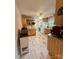 The eat-in kitchen has lovely marble tile flooring, wood cabinets and a ceiling fan at 403 Kings Dr, Cherryville, NC 28021