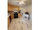 This kitchen features matching marble tile floors and wood cabinets, with a view into the hallway at 403 Kings Dr, Cherryville, NC 28021