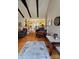 Cozy living area with exposed beam ceiling, hardwood floors, and vintage furniture at 403 Kings Dr, Cherryville, NC 28021