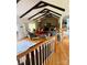 Open living room with exposed beam ceiling, brick fireplace, and hardwood floors at 403 Kings Dr, Cherryville, NC 28021