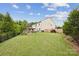 Expansive backyard with a well-maintained lawn, outdoor kitchen, and perimeter landscaping at 4430 Bravery Sw Pl, Concord, NC 28027