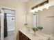 Bright bathroom showcasing dual sinks, a large mirror, and a shower at 4430 Bravery Sw Pl, Concord, NC 28027
