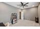 Neutral bedroom features gray walls, ceiling fan, and carpeted floors at 4430 Bravery Sw Pl, Concord, NC 28027
