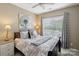 Bedroom with lots of natural light featuring a neutral palette and comfortable queen bed at 4430 Bravery Sw Pl, Concord, NC 28027