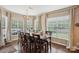 Sun-filled dining room featuring a chandelier, large windows, and seating for eight at 4430 Bravery Sw Pl, Concord, NC 28027