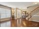 Bright foyer featuring hardwood floors, an elegant staircase, and a front door at 4430 Bravery Sw Pl, Concord, NC 28027