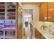 Hallway featuring a sliding barn door pantry and a view into the adjacent dining room at 4430 Bravery Sw Pl, Concord, NC 28027