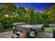 Outdoor hot tub with lush greenery, patio, and privacy fencing at 4430 Bravery Sw Pl, Concord, NC 28027