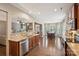 Open-concept kitchen with stainless steel appliances, granite countertops, and hardwood flooring at 4430 Bravery Sw Pl, Concord, NC 28027