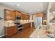 Spacious kitchen featuring wood cabinetry, granite countertops, stainless steel appliances, and hardwood floors at 4430 Bravery Sw Pl, Concord, NC 28027