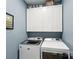 Efficient laundry room with white cabinets, modern washer and dryer, and stylish decor at 4430 Bravery Sw Pl, Concord, NC 28027