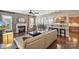 Spacious living area features a fireplace, plush seating, and access to dining and kitchen areas at 4430 Bravery Sw Pl, Concord, NC 28027