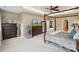 Spacious main bedroom featuring a four-post bed, sitting area, and neutral color palette at 4430 Bravery Sw Pl, Concord, NC 28027