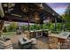 Outdoor kitchen with stone countertops, stainless steel appliances, and a built-in bar at 4430 Bravery Sw Pl, Concord, NC 28027
