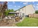 Outdoor patio features a built-in fire pit, wood storage, seating, and a built-in outdoor kitchen at 4430 Bravery Sw Pl, Concord, NC 28027
