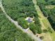 Aerial view of a beautiful wooded property with a well-maintained home surrounded by mature trees and lush landscape at 5033 Waxhaw Indian Trail Rd, Matthews, NC 28104