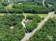 Scenic aerial view of the property surrounded by lush trees and greenery, located in a beautiful, private setting at 5033 Waxhaw Indian Trail Rd, Matthews, NC 28104