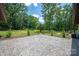 Large backyard patio with mature trees and expansive green space, perfect for outdoor entertaining at 5033 Waxhaw Indian Trail Rd, Matthews, NC 28104