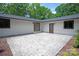 Backyard patio with doors to enter the property and neat landscaping and mulching at 5033 Waxhaw Indian Trail Rd, Matthews, NC 28104