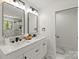 Modern bathroom with dual sinks, marble countertops, and a walk-in shower at 5033 Waxhaw Indian Trail Rd, Matthews, NC 28104