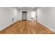 Spacious bedroom with hardwood flooring, base trim, closet, and interior door at 5033 Waxhaw Indian Trail Rd, Matthews, NC 28104