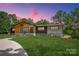 Beautiful home featuring a well-manicured lawn and a charming facade, perfect for modern living amidst a natural setting at 5033 Waxhaw Indian Trail Rd, Matthews, NC 28104