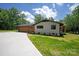 Exterior view of home showcasing attached garage and side entrance at 5033 Waxhaw Indian Trail Rd, Matthews, NC 28104