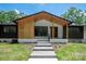 Beautiful front entrance of home with modern wood details and walkway at 5033 Waxhaw Indian Trail Rd, Matthews, NC 28104