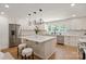 Well-appointed kitchen features stainless steel appliances, marble countertops, and custom cabinets at 5033 Waxhaw Indian Trail Rd, Matthews, NC 28104