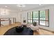 Cozy living area featuring large window, seating, and hardwood floors at 5033 Waxhaw Indian Trail Rd, Matthews, NC 28104