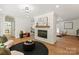 Cozy living room featuring modern fireplace, stylish furnishings, and hardwood flooring at 5033 Waxhaw Indian Trail Rd, Matthews, NC 28104