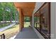 Covered porch with natural wood detail, offering great curb appeal and design at 5033 Waxhaw Indian Trail Rd, Matthews, NC 28104