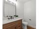 Stylish powder room with a wood vanity, marble countertop, and modern fixtures at 5033 Waxhaw Indian Trail Rd, Matthews, NC 28104