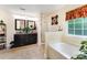 Bright bathroom featuring double sinks, a soaking tub, and a separate shower at 530 Shady Oaks Dr, Stanley, NC 28164