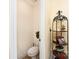 Powder room with neutral walls, decorative shelving, and a modern toilet at 530 Shady Oaks Dr, Stanley, NC 28164