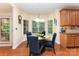 Breakfast nook with a glass top table, four upholstered chairs, and a large window with a view of the backyard at 530 Shady Oaks Dr, Stanley, NC 28164