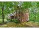 Brick two-story home with landscaped yard and mature trees providing shade at 530 Shady Oaks Dr, Stanley, NC 28164